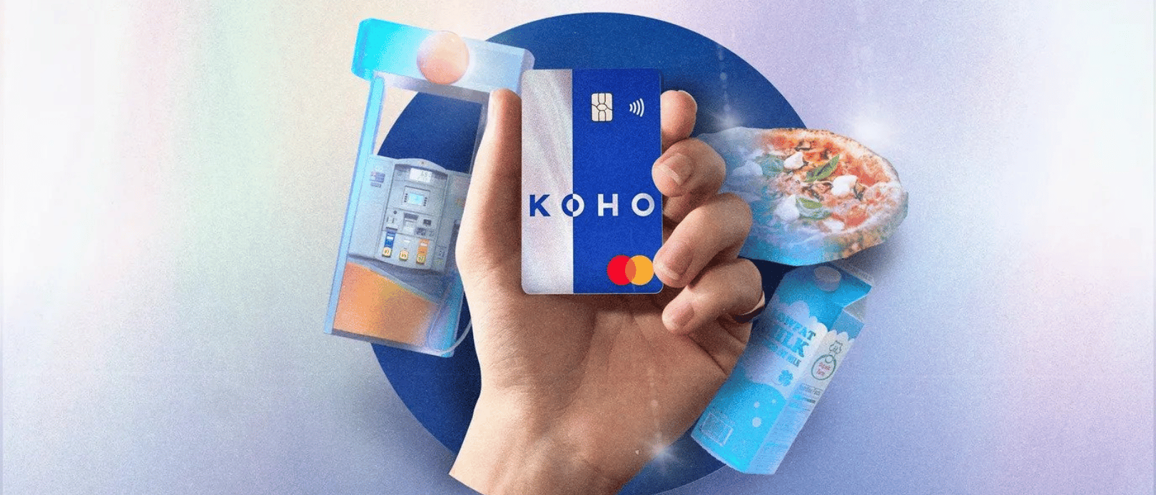 Hand holding KOHO Extra card with surrounded by atm milk and pizza